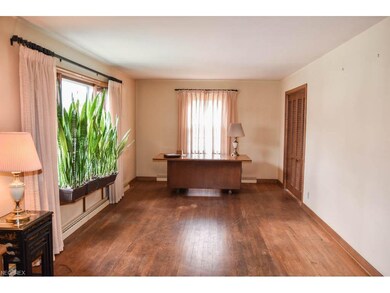 The living room has hardwood flooring and a large 