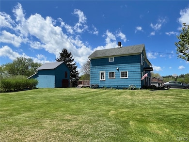Side yard and outbuilding! Nice large corner lot.
