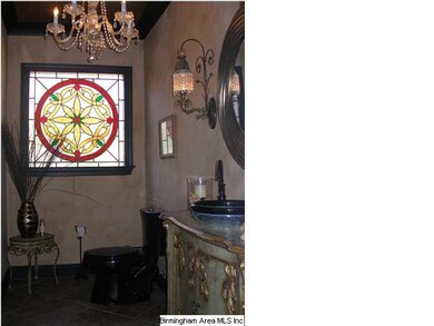 Powder room with antique sink and stained glass wi
