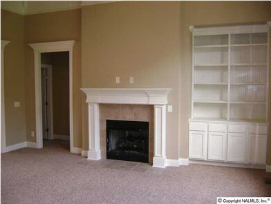 Great room with vaulted ceiling and built in book cases.