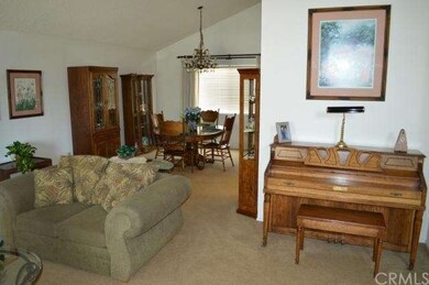 View of living room, entry and formal dining room.