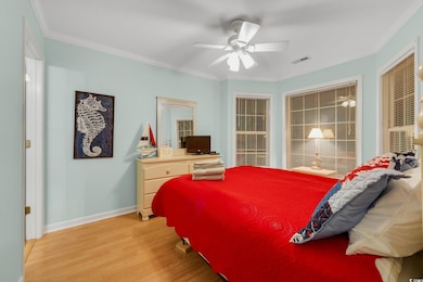 Bedroom featuring ceiling fan, crown molding, and 