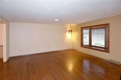 Hardwood floors flow from the living room to the d