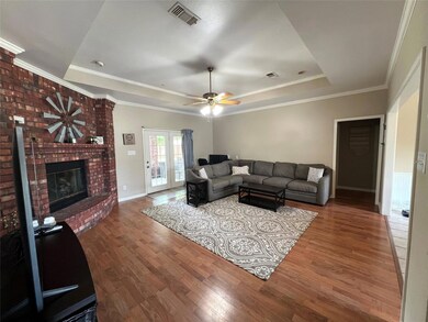 Living room featuring ceiling fan, french doors, h