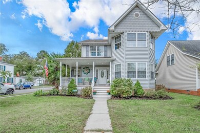 View of front facade with a front yard and covered