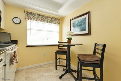Dining area with light tile patterned floors and baseboards