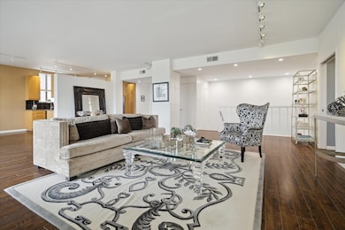 This spacious living area features hardwood floors