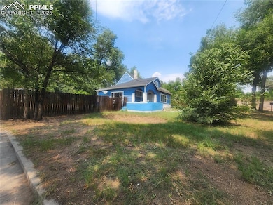 Back of house featuring a chimney