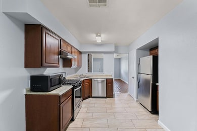 Kitchen featuring appliances with stainless steel