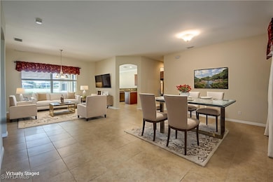 Dining room featuring a chandelier, light tile pat