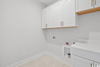 Washroom with cabinet space, hookup for a washing machine, and electric dryer hookup