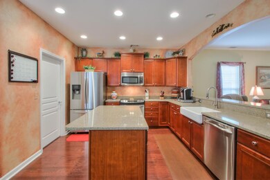 Granite counter-tops, stainless appliances, recessed lighting, arched wall and hardwood floors. . 