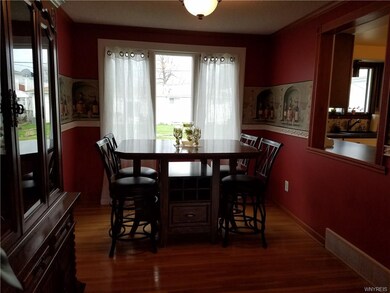 Formal dining room with hardwood flooring.