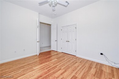 Unfurnished bedroom with ceiling fan, light hardwo