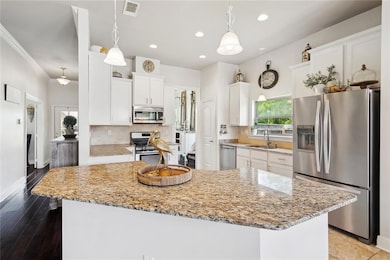 White kitchen with stainless appliances
