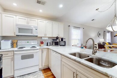 Kitchen with sink, white appliances, white cabinet