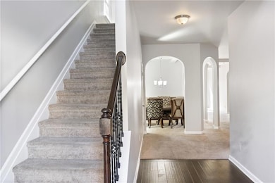 Stairs featuring hardwood / wood-style floors and 