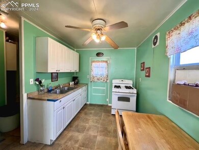Kitchen with ceiling fan, white gas stove, white c