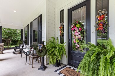 This welcoming front porch features a stylish blac