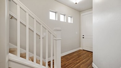 Foyer featuring dark wood finished floors and stairs