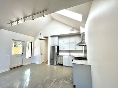 Kitchen with rail lighting, wall chimney range ho