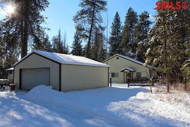 2 car garage with shop in background.