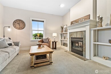 To the left as you enter the home, a charming den with cozy gas fireplace and built-ins.