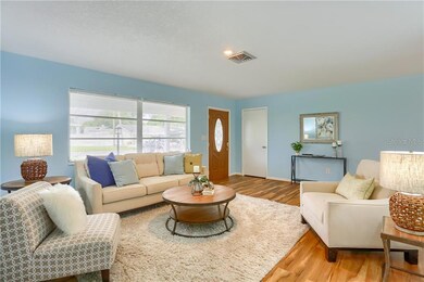 View of living room from hallway.  Coat/storage closet to the right of the front door.