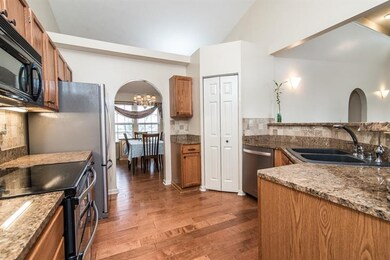 Kitchen with granite counter tops, bar island and 