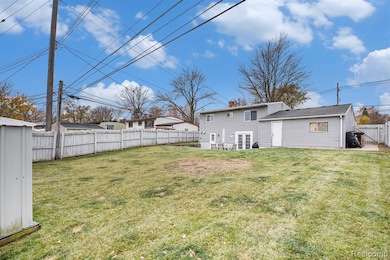 Back of property with a fenced backyard, and French doors