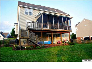 The back of the home offers a screened porch and l