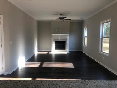 Unfurnished living room with baseboards, ceiling f