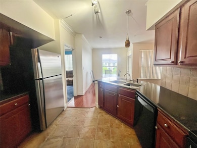 Kitchen featuring a sink, freestanding refrigerat