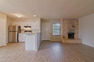 Kitchen featuring white cabinetry, freestanding r