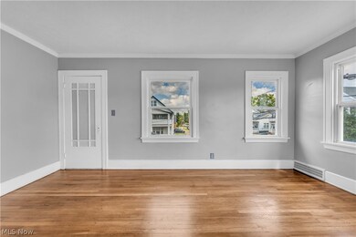Empty room featuring light hardwood / wood-style floors and crown molding