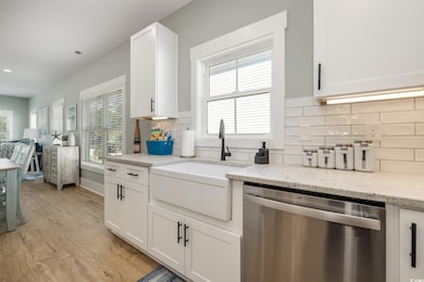 Kitchen with dishwasher and white cabinetry