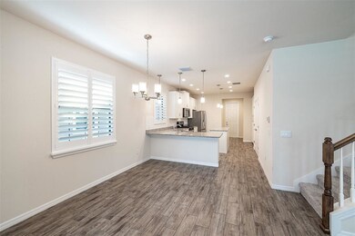 Open concept with wood look tile flooring.