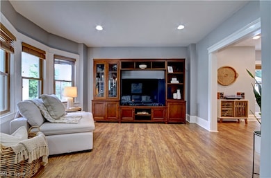 Living room featuring plenty of natural light and light hardwood / wood-style flooring