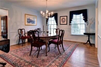 Spacious formal Dining Room with hardwood floors opens to Family Room.