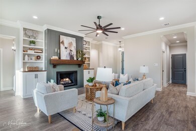 Living room with built in features, a fireplace, d
