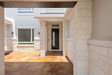 Entrance to property with stone siding