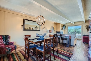 Dining area featuring wood walls, an inviting chan