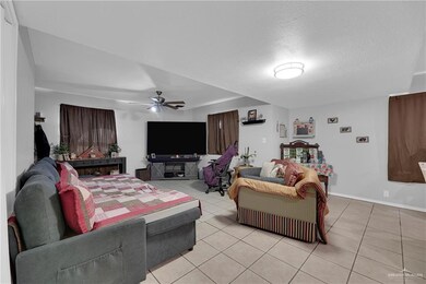 Living room featuring tile flooring and ceiling fan