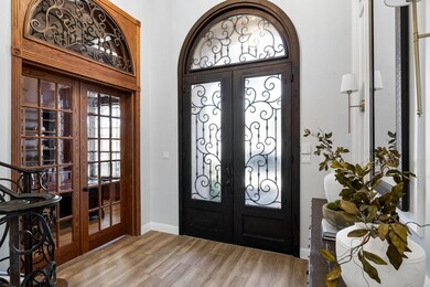 Entryway with light wood finished floors, french d