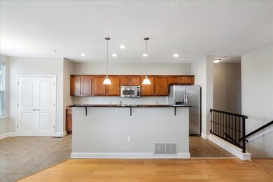 Kitchen featuring light wood-type flooring, dark c