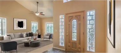 Entrance foyer with a ceiling fan and high vaulted ceiling