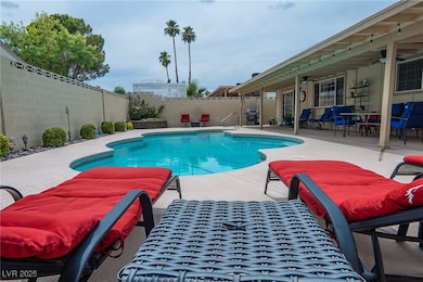 View of pool with a fenced backyard, a patio area,