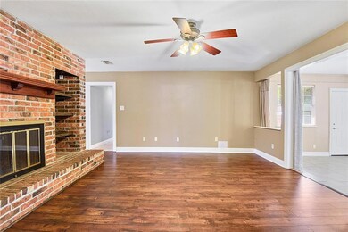 View of Den with wood burning Fireplace from the K