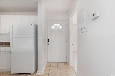 Doorway to outside with light tile patterned floor
