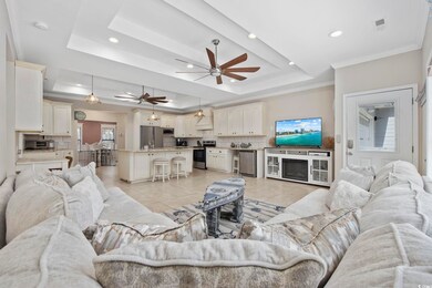 Living room featuring visible vents, crown molding